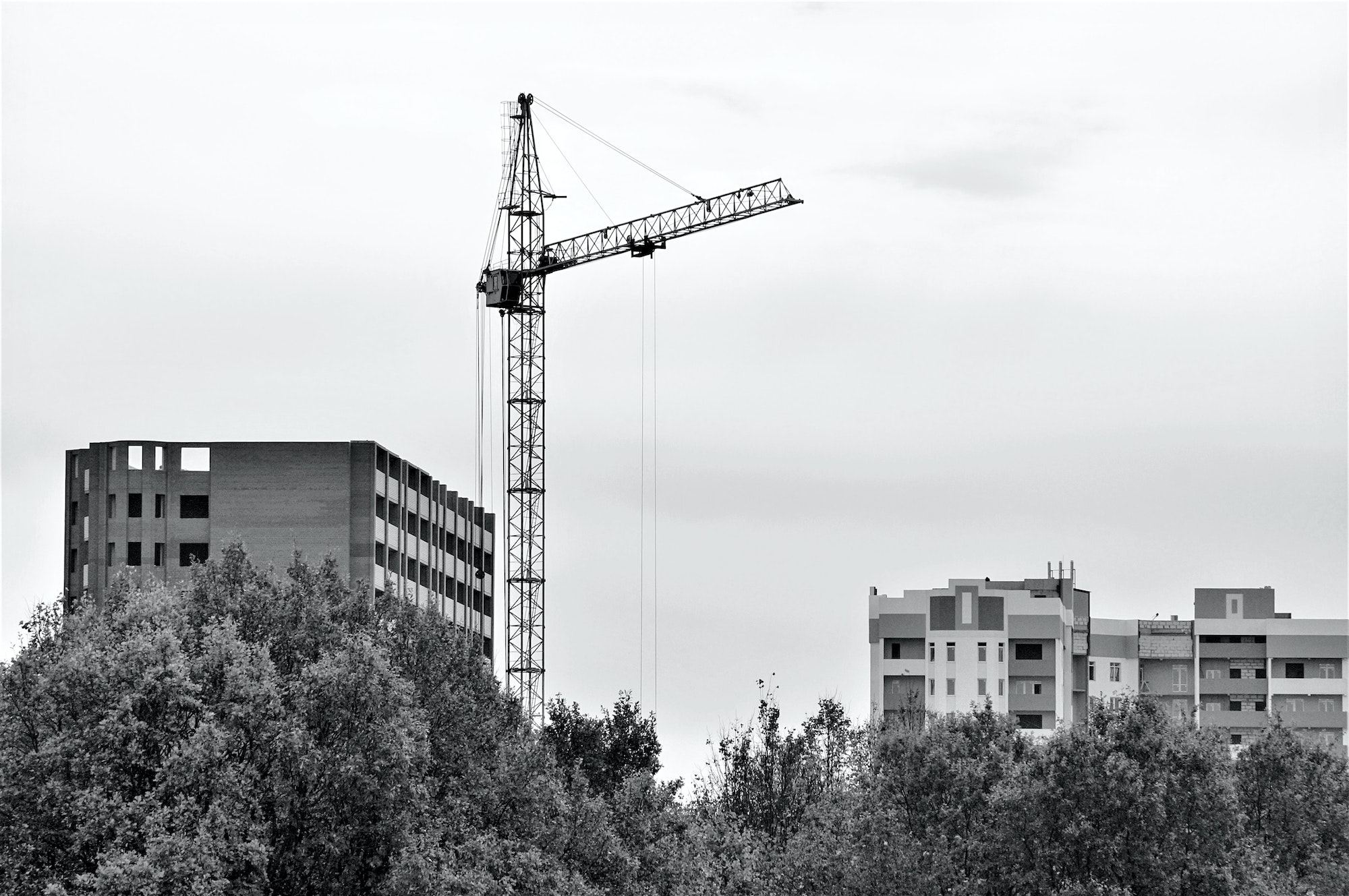 High crane next to a building under construction